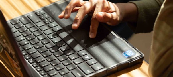 Close-up of hands on a laptop computer